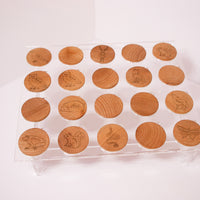 Matching game with stylized woodland animals laser burned on wooden coins being displayed on an acrylic stand.  Some of the coins are turned around backwards as if the game is in play